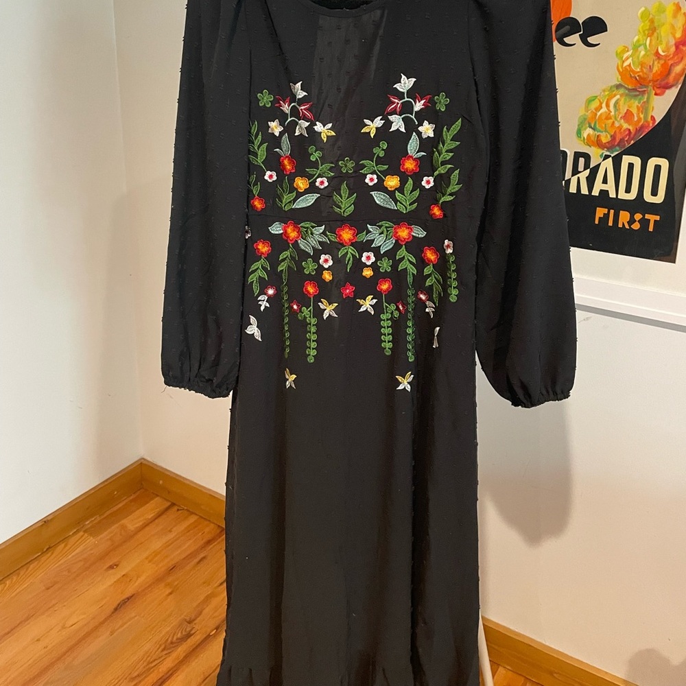 Black boho dress with embroidered flowers.